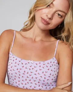 Detail of lavender floral camisole featuring lace trim and a white ribbon bow tie