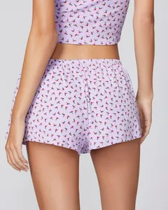 Rear view of two-piece purple floral sleepwear set with lace trim and elastic shorts