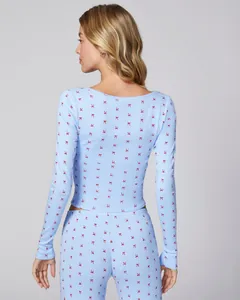 Detail view of light blue pajamas set with red bow print showing back cut and fabric