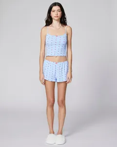 Detail of light blue two-piece home wear set with red bow prints and lace trim edges