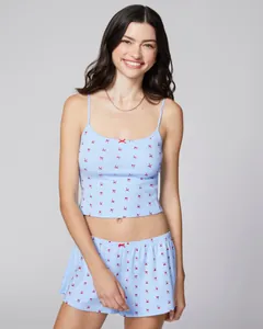 Close-up of light blue floral lace camisole and shorts with red bow print details