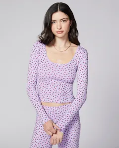 Close-up of lilac ribbed knit pajama set with red cherry print and delicate lace trim
