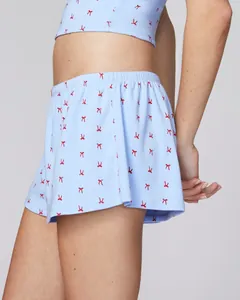Detail of light blue floral lace camisole and shorts set with red bow prints