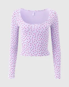 Close-up of lilac ribbed cotton sleepwear with red floral patterns and lace trim