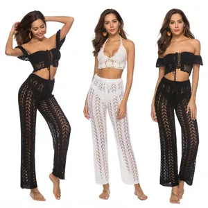 Conjunto playero de ganchillo con top corto y pantalones anchos calados en blanco y negro