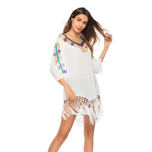 White crochet beach cover-up with colorful knit rings and long bohemian fringes