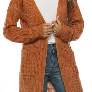 Détail du cardigan en maille orange montrant la texture épaisse et une grande poche latérale