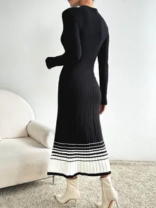 Détail de l'ourlet plissé en tricot et rayures noires et blanches sur la robe pull longue