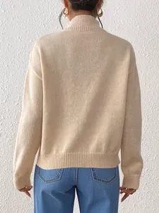 Back view of apricot knitted sweater featuring drop shoulders and ribbed cuffs for fall