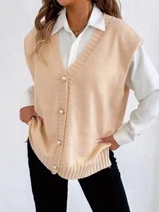 Detailed view of apricot knitted vest with elegant pearl buttons and V-neckline texture