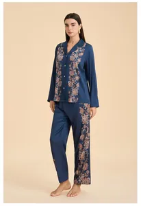 Detail of navy satin pajama set showing ethnic floral print on long sleeves and pants