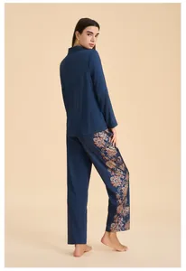 Detail of navy satin pajama set featuring intricate paisley print on the side of trousers