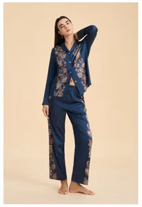 Detail of navy blue satin loungewear set featuring floral print on collar and sleeves