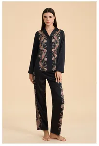 Detail of satin floral paisley print on black long sleeve pajama top and trousers
