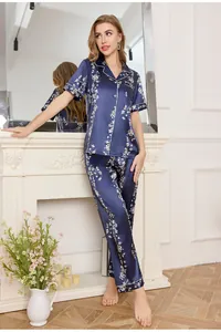 Detail of dark blue floral satin pajamas set with contrast piping and luxury texture