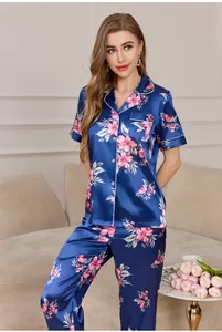 Detail view of smooth ice silk pajamas with floral print and white contrast piping