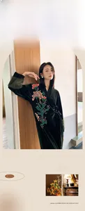 Detail of dark green velvet robe featuring exquisite floral embroidery and retro design