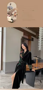 Detail of dark green velvet robe featuring intricate floral embroidery and side tie