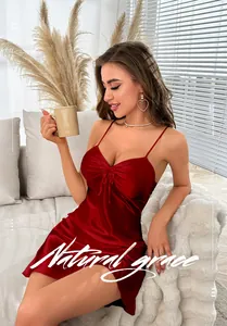 Detail of red silk slip nightgown with drawstring chest and side slit design