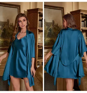 Detail of dark blue satin silk pajamas set showing camisole dress and belted robe texture