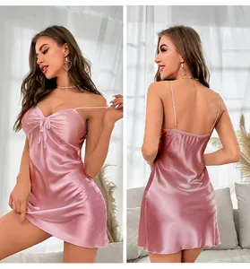 Detail of pink satin nightdress featuring delicate spaghetti straps and bow embellishment