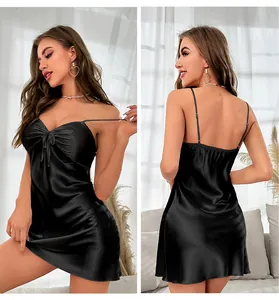 Detail of black satin slip nightdress featuring thin straps and backless design with bow