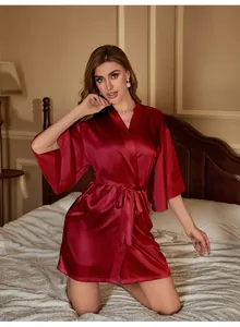 Close-up of elegant burgundy silk-satin robe with v-neckline and matching belt detail