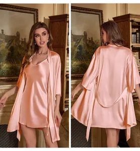 Detail of pink satin sleepwear set featuring V-neck chemise and matching belted robe