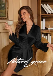 Elegant black silk long-sleeve robe with classic V-neck tie, shown in a cozy home setting