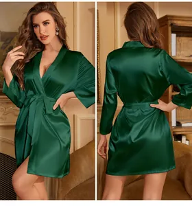 Detail of elegant dark green silk satin pajama robe with classic V-neck and waist tie