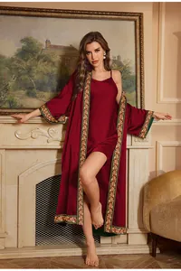 Close-up of wine red satin bathrobe set with luxury vintage embroidered green trim