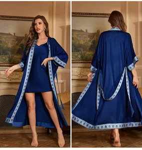 Elegant navy blue satin two-piece sleepwear set with floral trim on a luxurious robe