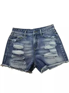 High-waisted blue washed denim shorts featuring distressed holes and raw frayed hems