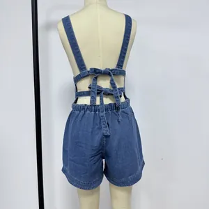 Detail view of denim overalls back with dual bow-knot ties and elastic waist design