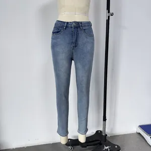 Detailed front view of high waisted skinny jeans in medium blue washed stretch denim