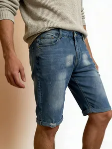 Men's light blue distressed denim shorts with ripped details and folded hems in casual style