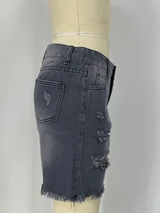 Detail view of charcoal grey high-waisted denim shorts featuring distressed ripped effects