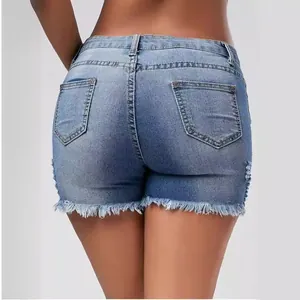 Women's low waist denim shorts in light blue wash with frayed edges and ripped details