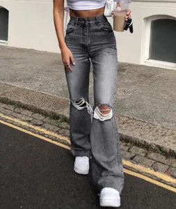 Detail shot of smoke grey high-waisted distressed denim jeans with knee rips