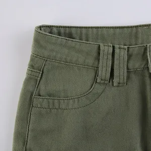 Detail of waist structure on olive green cotton trousers with belt loops and stitching