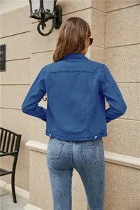 Rear view of cropped denim jacket in blue-violet featuring classic vertical stitch details