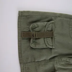 Close-up of army green cargo skirt detail with metal D-ring and utility pocket