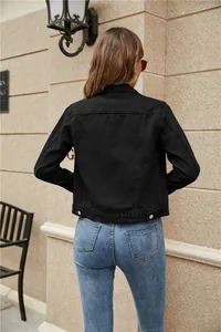 Rear view of slim fit black denim jacket featuring classic stitching and metal buttons