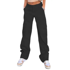 Detail of high waisted black cargo pants featuring large flap pockets and straight leg cut