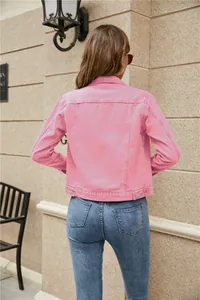 Detailed back view of a slim-fit pink denim jacket with contrast stitching outdoors