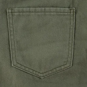 Detailed macro view of olive green twill fabric and double-stitched back pocket design