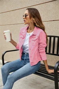 Close-up of pink denim jacket for women with lapel collar and metal buttons in outdoor setting