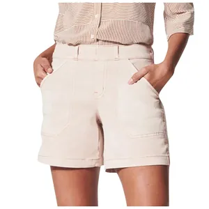 Detail view of light pink high-waist cotton shorts featuring large pentagonal front pockets