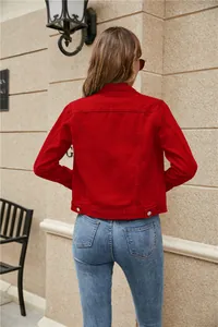 Back view of a red cropped denim jacket with neat stitching and metal buckle waist tabs