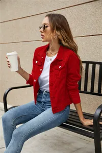 Detail of red slim fit denim jacket with metal buttons and classic collar design